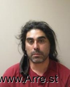 Miguel Kicking Buck Flores Mugshot